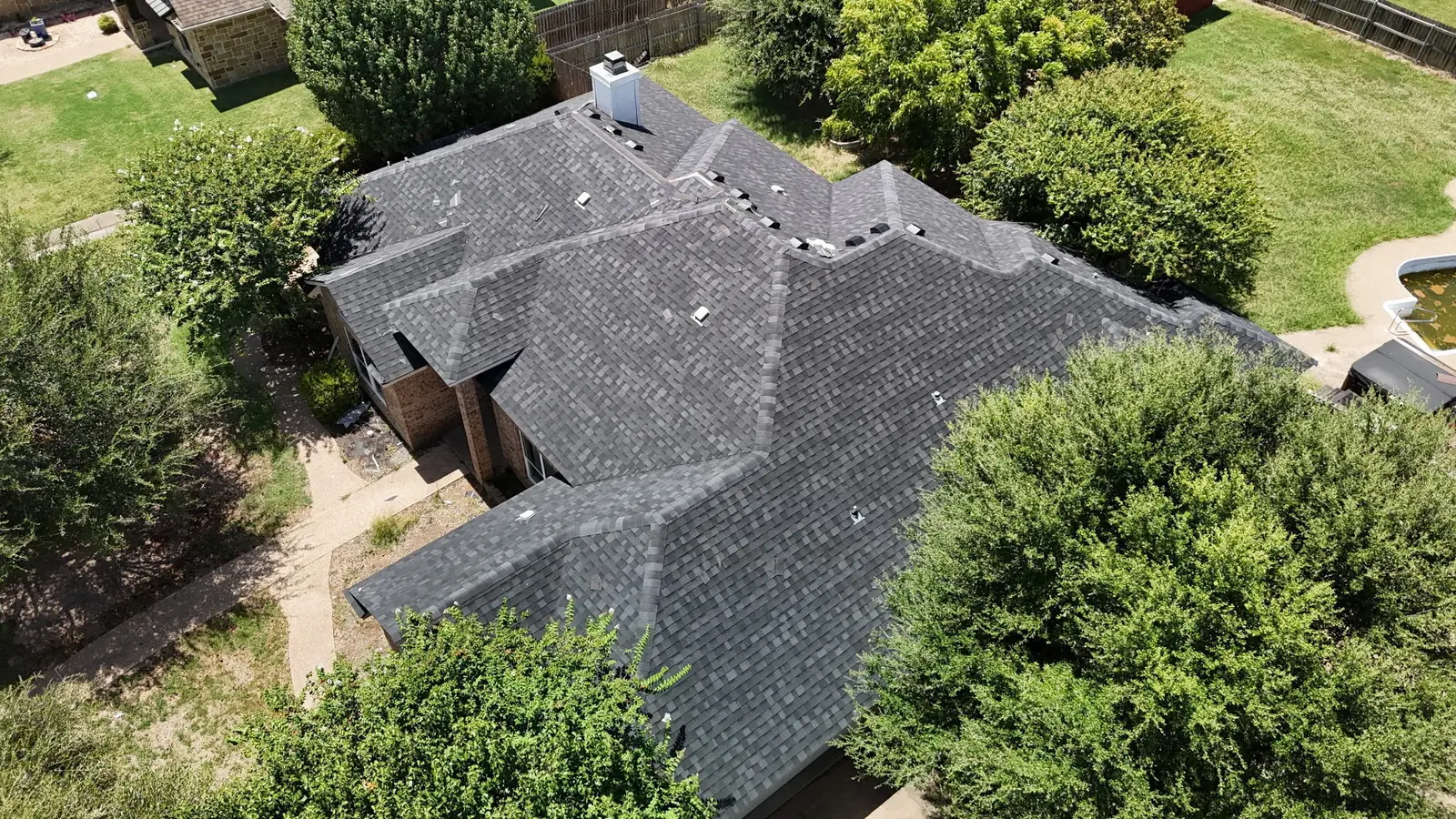 A finished shingle roof replacement on a Waco home, seen from above