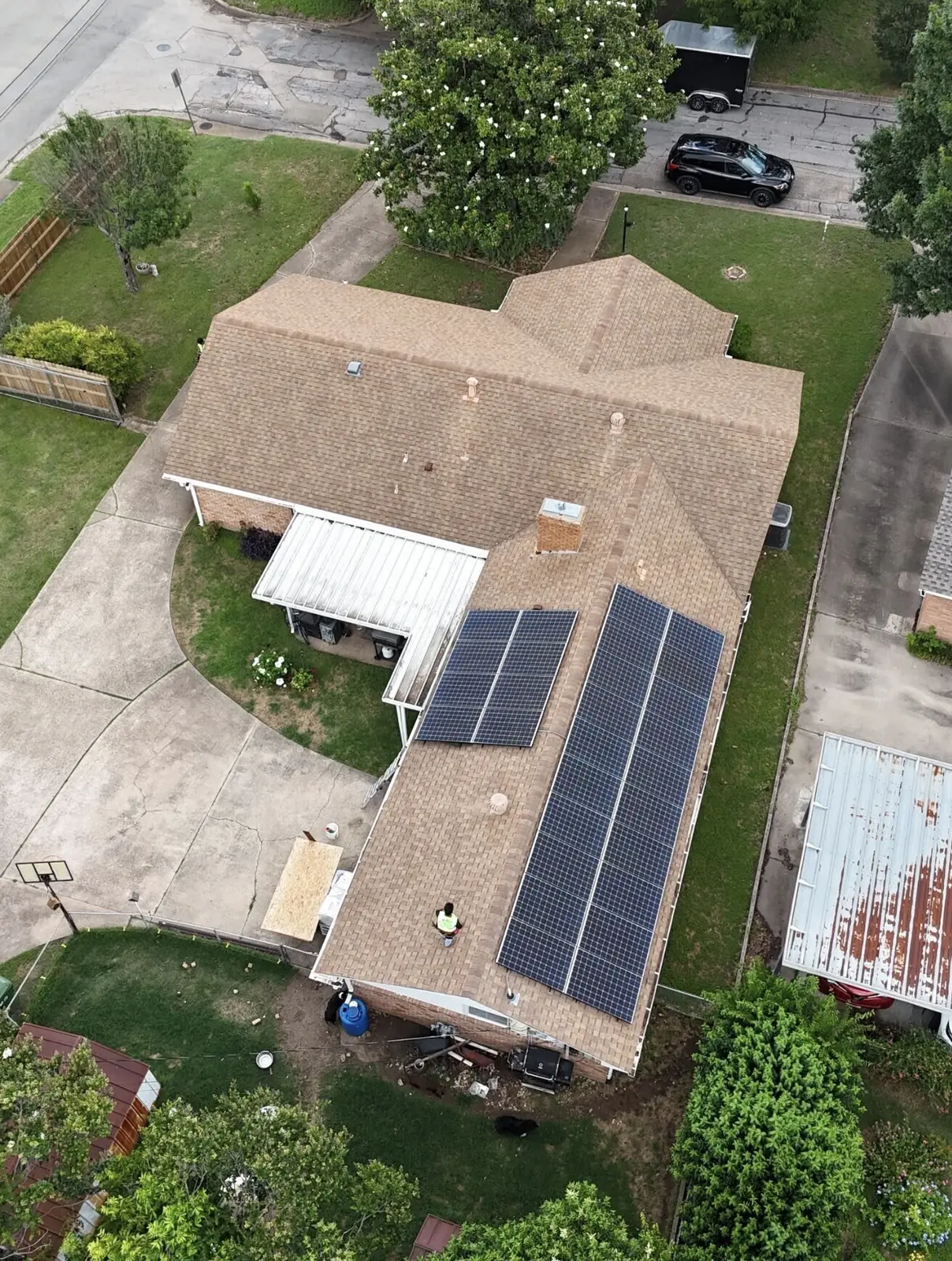 Roof mounted solar panels on a Waco home with work under way, seen from above